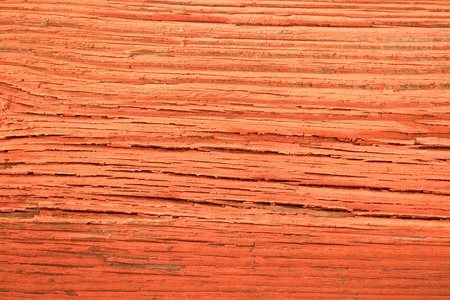 Red painted, sunburned wall plank texture backgroundの写真素材