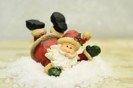 One santa claus decoration figurine on the artificial snow in studioの写真素材