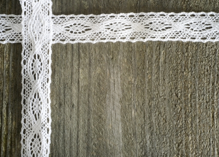White lace on the wooden gray background, rusticの写真素材