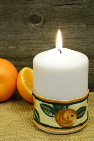 A candle decorated with a nice ribbon and clementines, rustic still-lifeの写真素材