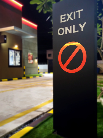 Exit Only Sign in front of a Fast Food Drive Throughの写真素材