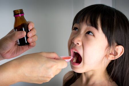 Sick Child Forced to Take Medical Syrupの写真素材