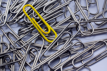 Yellow Paperclips Among a Group of Silversの写真素材