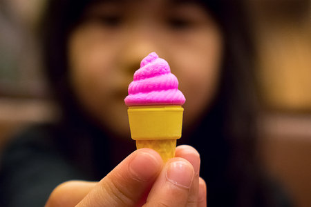 Rubber Toy Strawberry Ice Cream Cone Displaying with Handの写真素材