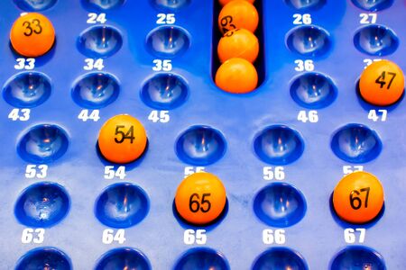 Blue Plastic Panel with Orange Bingo Ballsの写真素材
