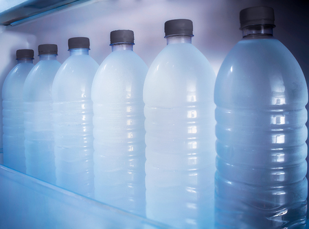 Fresh and Chilled Bottles of Drinking Water in the Fridgeの写真素材