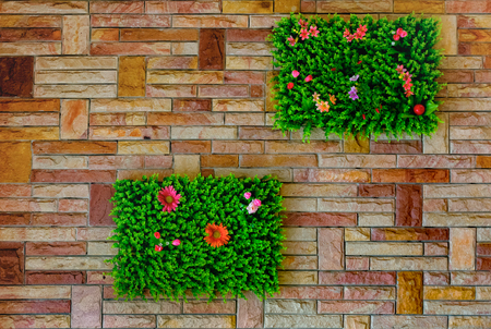 Brick Wall with Artificial Garden Patches as Decorationの写真素材