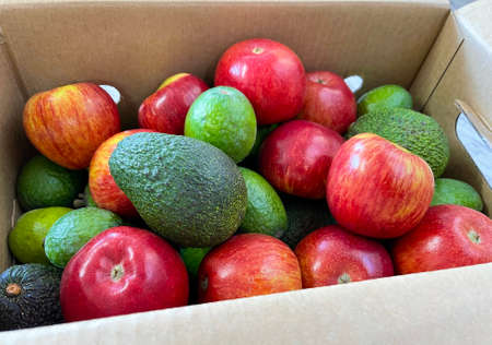 Food delivery box of fresh fruits such as avocado, apple and feijoa