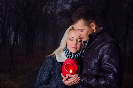 Couple with lantern  heart  in the park at nightの写真素材