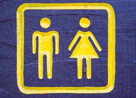 Man   Woman restroom sign on woodの写真素材