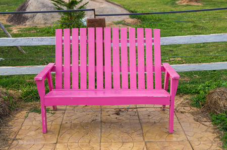 Pink bench in gardenの写真素材