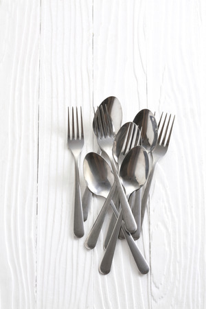 silver spoons on white tableの写真素材