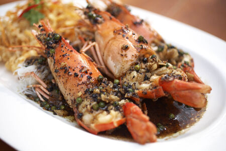 shrimp in pepper sauce on wooden tableの写真素材