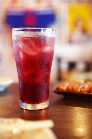 close up grape juice in glass on wooden tableの写真素材