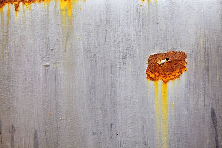 close up old black and yellow metal wall