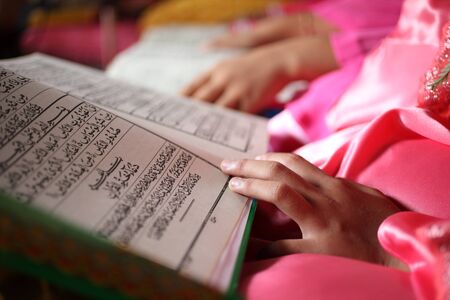 close up muslim child and book in schoolの写真素材