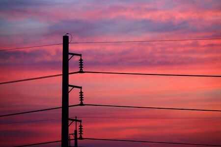 electricity post in sunsetの写真素材