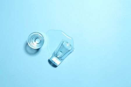 Vodka in shot glass on blue background with a blank space for a text, Russian vodka on color tableの写真素材