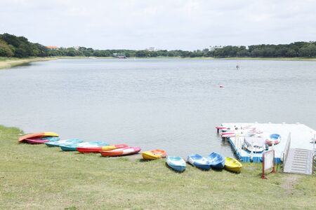 old color cayak on grass in lake