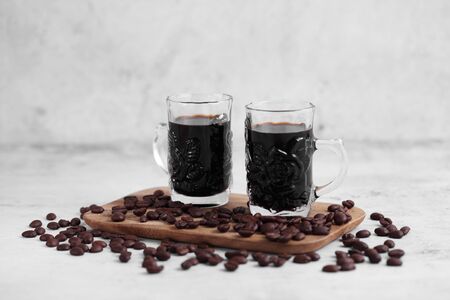 Coffee in cup and coffee beans on rustic table with a blank space for a text, Espresso in cup on white backgroundの写真素材