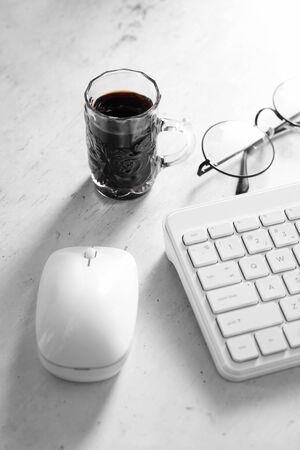 Coffee in cup and computer on rustic table with a blank space for a text, Espresso in cup on white backgroundの写真素材