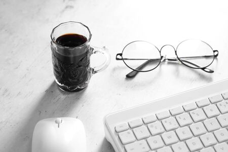 Coffee in cup and computer on rustic table with a blank space for a text, Espresso in cup on white backgroundの写真素材