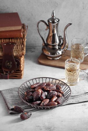 dates fruit and Arab tea on a white concrete background with a blank space for a text, dates fruit on a white backgroundの写真素材