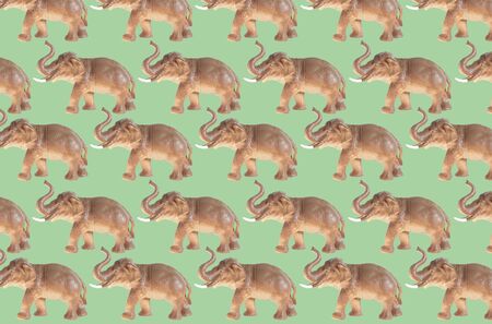 Plastic elephant doll isolated on color backgroundの写真素材