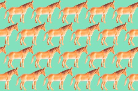 Plastic horse doll isolated on color backgroundの写真素材