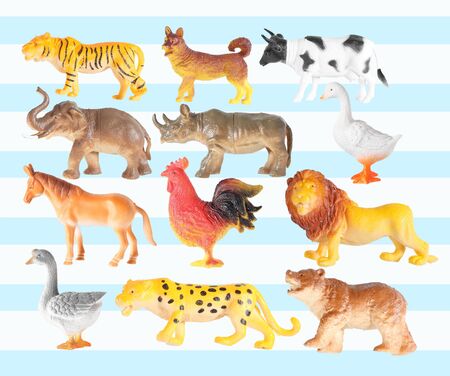 Group of plastic animal doll isolated on color background