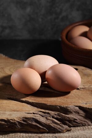 Group of of raw chicken eggs on rustic background, Organic eggs in loft style kitchen
