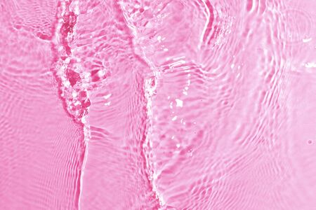 texture of splashing clean water on pink backgroundの写真素材