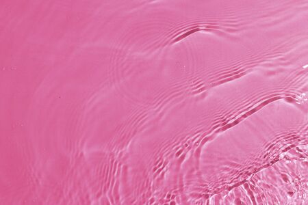 texture of splashing clean water on pink backgroundの写真素材