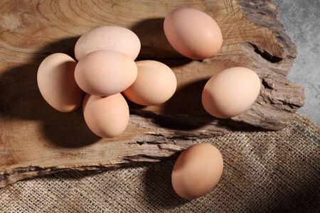 Group of of raw chicken eggs on rustic background, Ingredient for Scrambled eggs in loft style...
