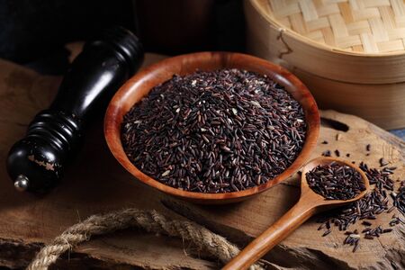 close up riceberry rice in measuring cup on table, riceberry rice in chinese kitchen backgroundの写真素材