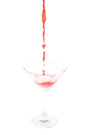 pouring cocktail with splashes isoalted on white backgroundの写真素材