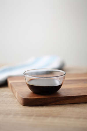 Chinese soy sauce in small cup on wooden tableの写真素材