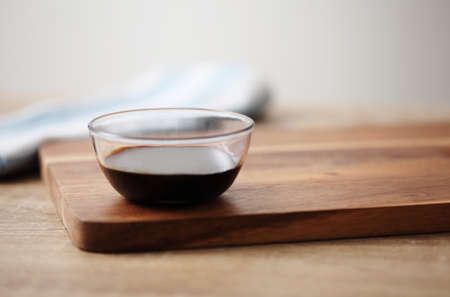 Chinese soy sauce in small cup on wooden tableの写真素材
