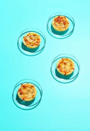 Mini pie from meat and mushrooms in metal tray on pastel backgroundの写真素材