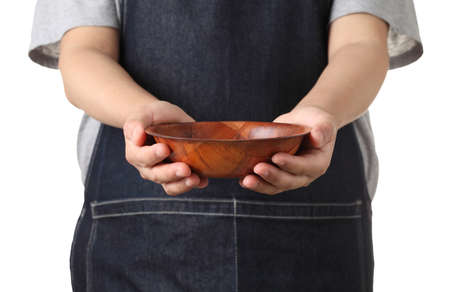 Chef holding wooden cup isolated on white backgroundの写真素材