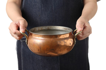 Young woman girl holding copper soup pot isolated on white background