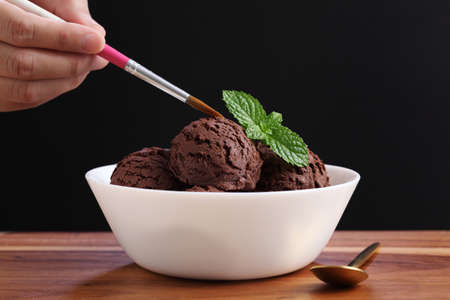 Food stylist use paintbrush decorating fake icecream for photography