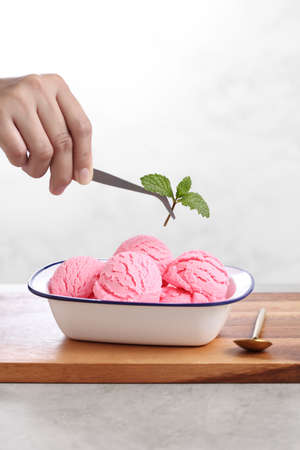 Food stylist use tweezers decorating fake icecream for photography