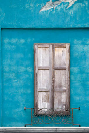 wooden vintage window on color cement wall in italian style