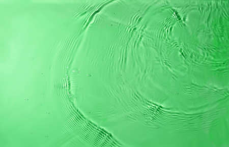 texture of splashing clean water on green backgroundの写真素材