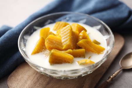 Thai dessert from pumpkin and coconut milk on wooden trayの写真素材