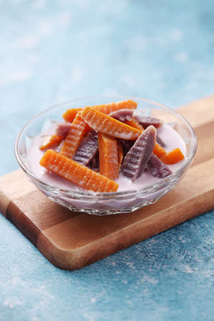 Thai dessert from sweet potato and coconut milk on wooden trayの写真素材