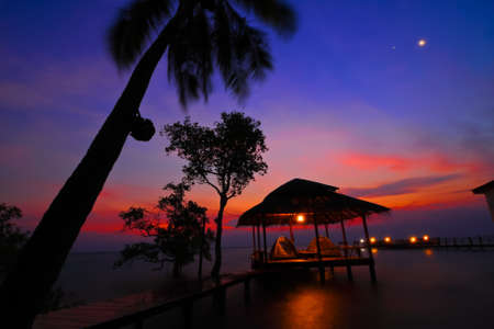 Summerhouse on the sea with moon and star.の写真素材