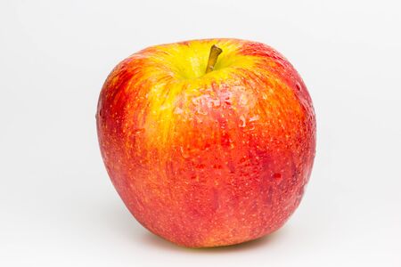 Red Apple with drops of water on white background の写真素材
