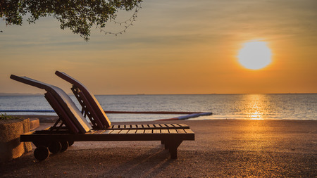 Picture of beach chair on beach at sunset.の写真素材